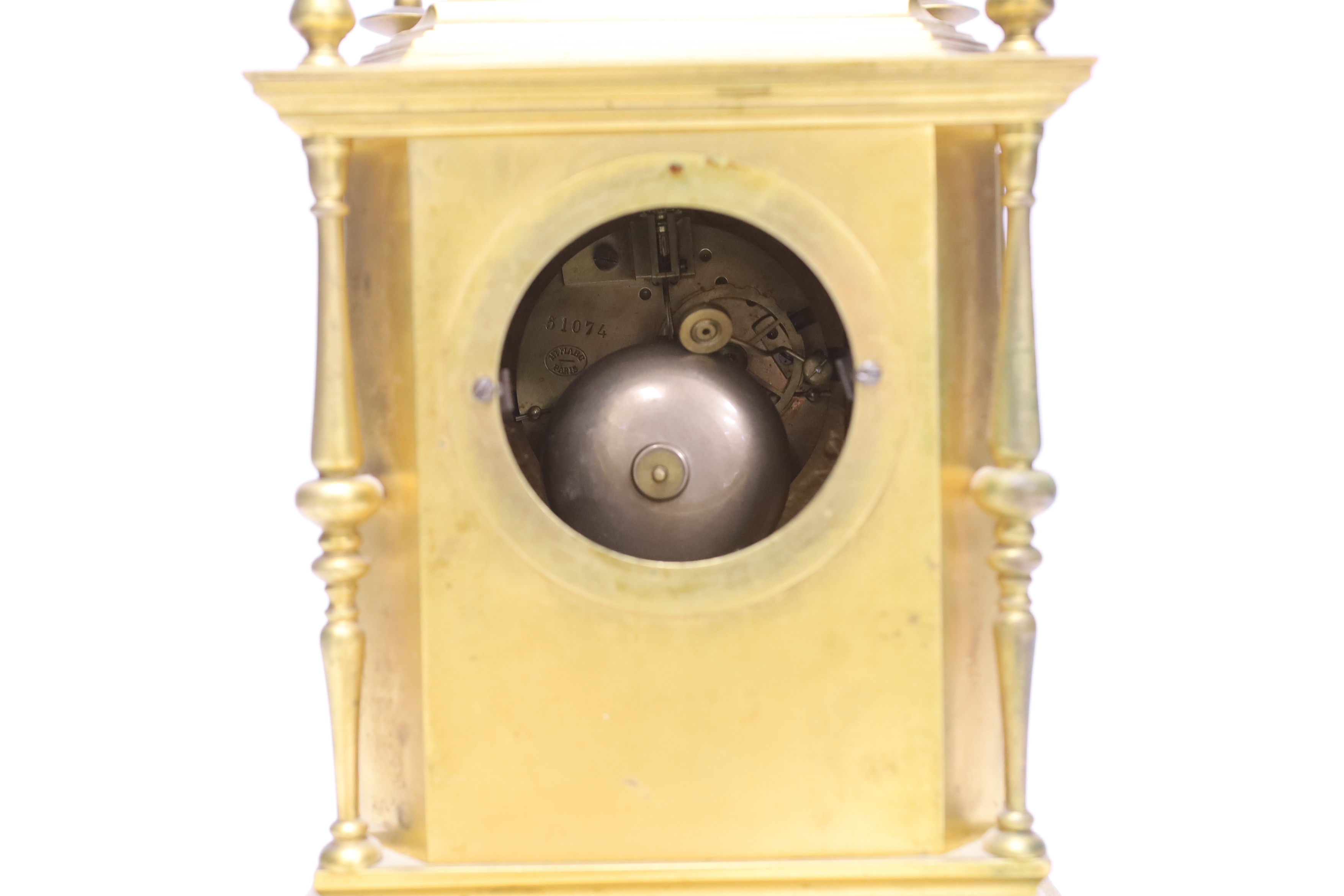 A late 19th/early 20th century French champleve and gilt metal clock garniture, 37cm